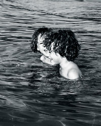 Portrait of shirtless boy swimming in pool