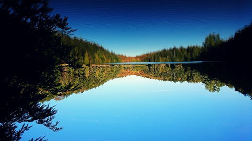 Scenic view of lake against clear blue sky