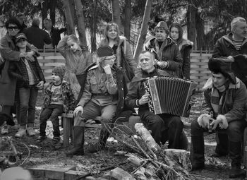 Group of people standing by tree