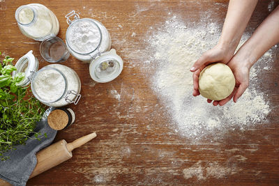 Cropped hand preparing food at table