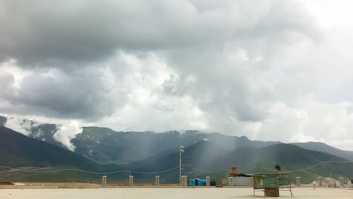 Scenic view of mountains against cloudy sky