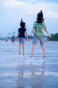 Rear view of women on beach