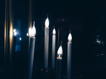 Close-up of lit candles in temple