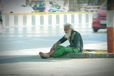 Full length of woman sitting on bench