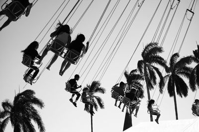 Low angle view of people at amusement park