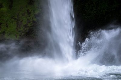 Scenic view of waterfall against sky