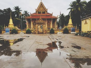 View of building and wet temple during rainy season