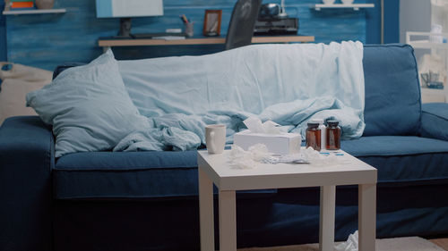 Woman sitting on bed at home