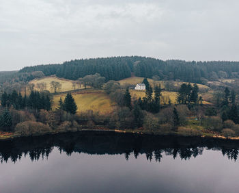 Reflection of trees in lake against sky