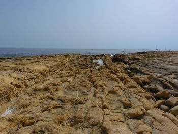 Scenic view of beach against clear sky