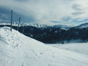 Scenic view of snow covered mountains against sky