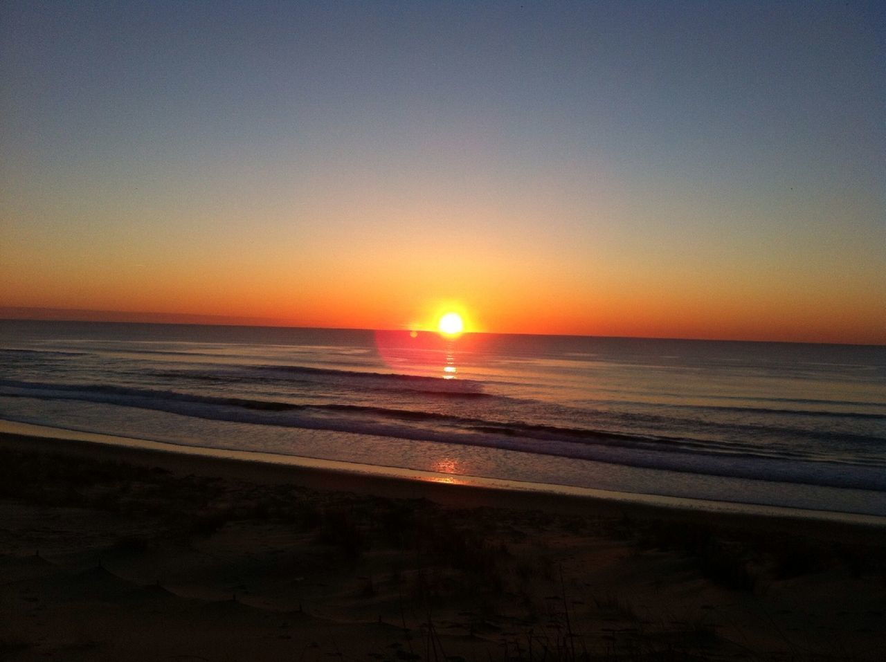 sunset, sea, horizon over water, sun, water, beach, scenics, tranquil scene, orange color, beauty in nature, tranquility, shore, clear sky, idyllic, nature, copy space, reflection, sunlight, sky, wave