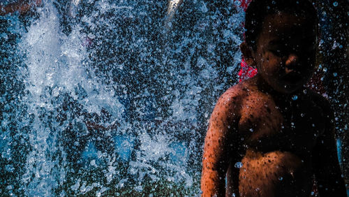 Full length of shirtless man in swimming pool