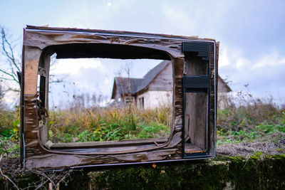 Close-up of car on field against sky