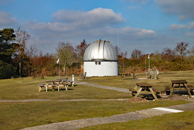 Built structure on field against sky