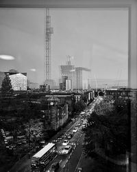 High angle view of city street and buildings against sky