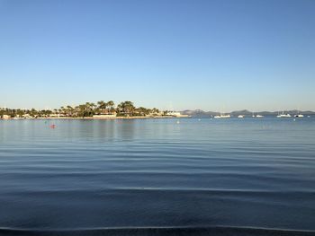 Scenic view of sea against clear blue sky