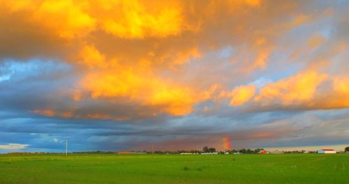 Scenic view of field against cloudy sky