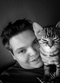 Portrait of cute boy with cat at home