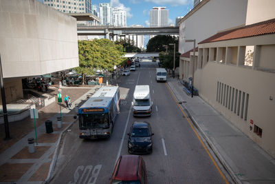 High angle view of vehicles on road amidst buildings