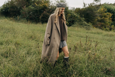 Rear view of woman standing on field