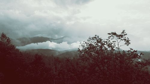 Scenic view of mountains against cloudy sky