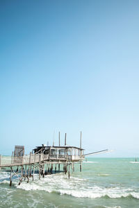 Scenic view of sea against clear blue sky