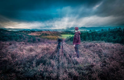 Man standing on field against sky
