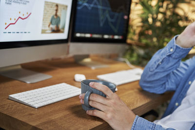 Midsection of man using laptop