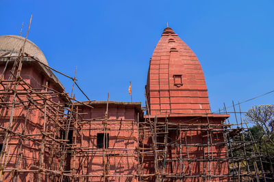 Low angle view of old building against clear blue sky