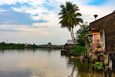 Scenic view of lake and houses against sky