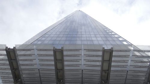 Low angle view of building against cloudy sky