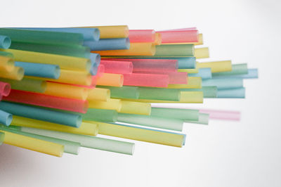 Stack of multi colored pencils against white background