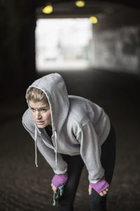 Sporty woman resting in tunnel