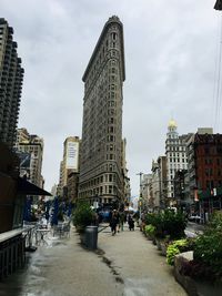 Street amidst buildings against sky in city