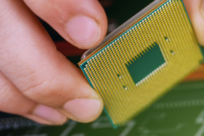 Close-up of hand holding computer chip