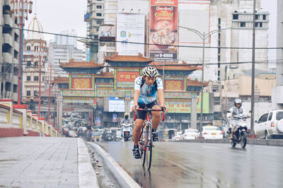 Woman riding bicycle on city street