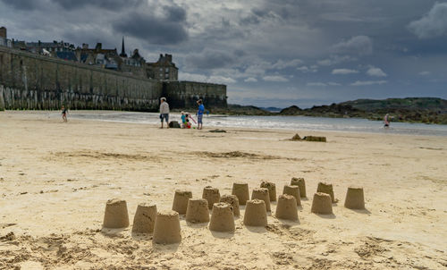 People on beach against sky