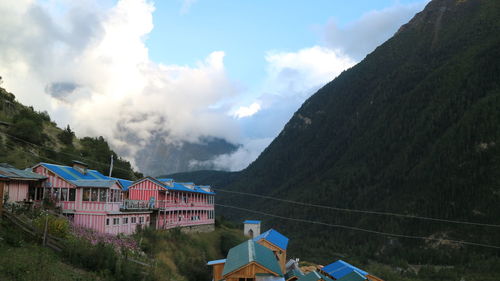 Panoramic view of buildings and mountains against sky