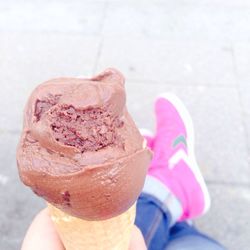 Cropped hand holding ice cream cone