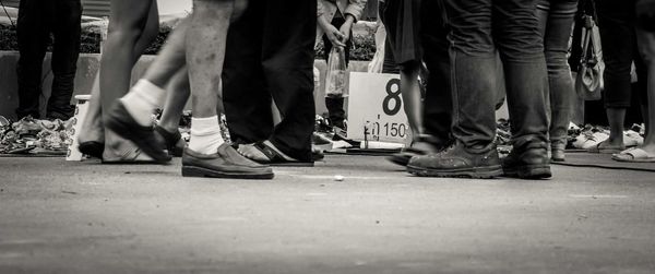 Low section of people walking on street