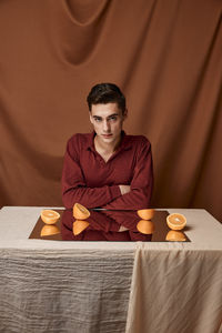 Portrait of man sitting on bed