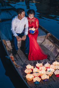 Full length of couple standing by water