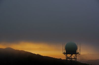 Scenic view of water tower against sky during sunset