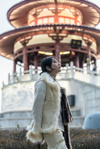 Portrait of young woman standing in temple