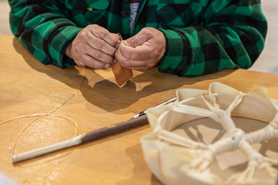 Midsection of senior woman doing craft