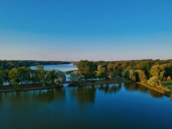 Scenic view of lake against clear blue sky