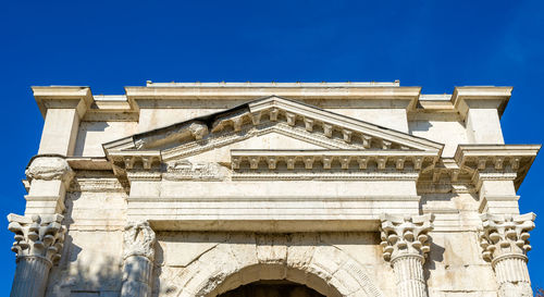 Low angle view of historical building against blue sky