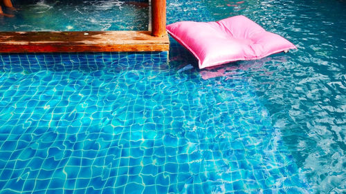 High angle view of pink floating on swimming pool
