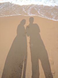 Shadow of people on beach